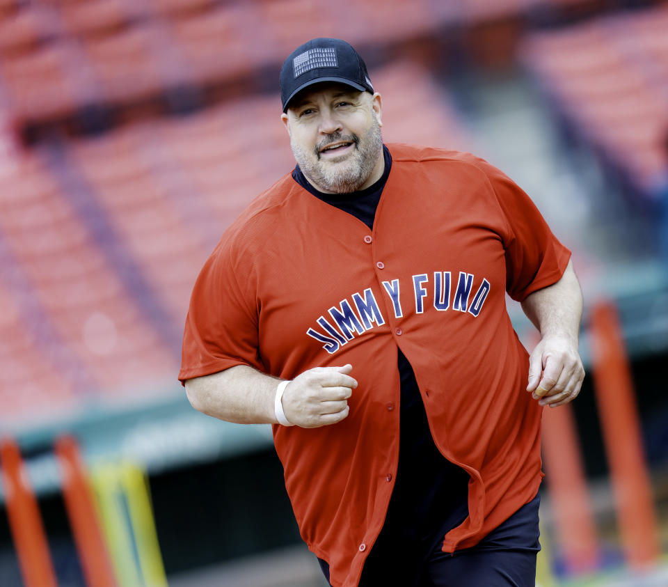 Kevin James, wearing a Jimmy Fund shirt, on the field at Fenway Park.