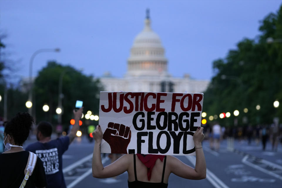 FILE - In this May 29, 2020, file photo, Demonstrators walk along Pennsylvania Avenue as they protest the death of George Floyd, a black man who died in police custody in Minneapolis in Washington. Black activists are coming out strongly against a growing narrative among conservatives that equates last week’s deadly siege on the U.S. Capitol to last summer’s Black Lives Matter protests over racial injustice. (AP Photo/Evan Vucci, File)