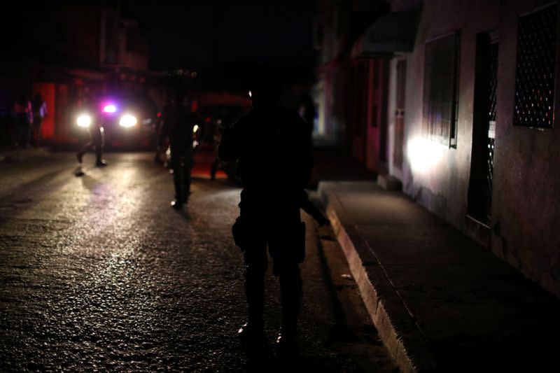 Members of the Special Action Force of the Venezuelan National Police (FAES) wait at a checkpoint during a night patrol, in Barquisimeto