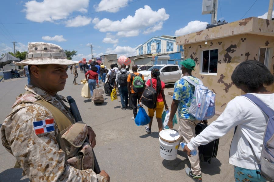 Dominican Republic security forces stand guard on a border bridge between Dajabón, Dominican Republic, and Haiti, Thursday, Sept. 14, 2023. (AP Photo/Ricardo Hernández)