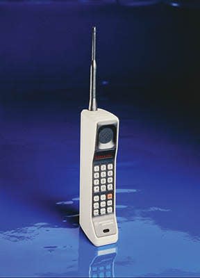 a white brick motorola dynatac 8000x with a royal blue background