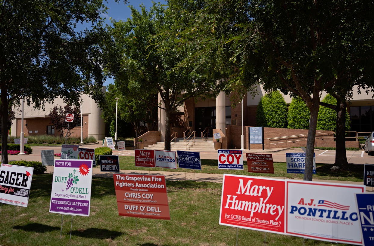 Image: signs of GCISD candidates outside Grapevine Library where people are casting their votes. (Danielle Villasana for NBC News)