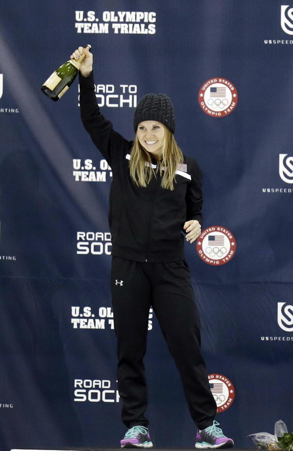 First-place finisher Jessica Smith celebrates on the podium after winning the women's 1,500 meters during the U.S. Olympic short track speedskating trials, Friday, Jan. 3, 2014, in Kearns, Utah. (AP Photo/Rick Bowmer)
