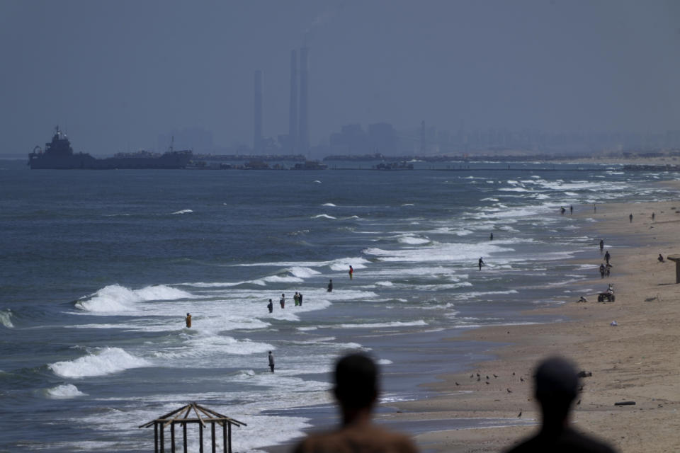 A ship is seen off the coast of Gaza near a U.S.-built floating pier that will be used to facilitate aid deliveries, as seen from the central Gaza Strip, Thursday, May 16, 2024. (AP Photo/Abdel Kareem Hana)