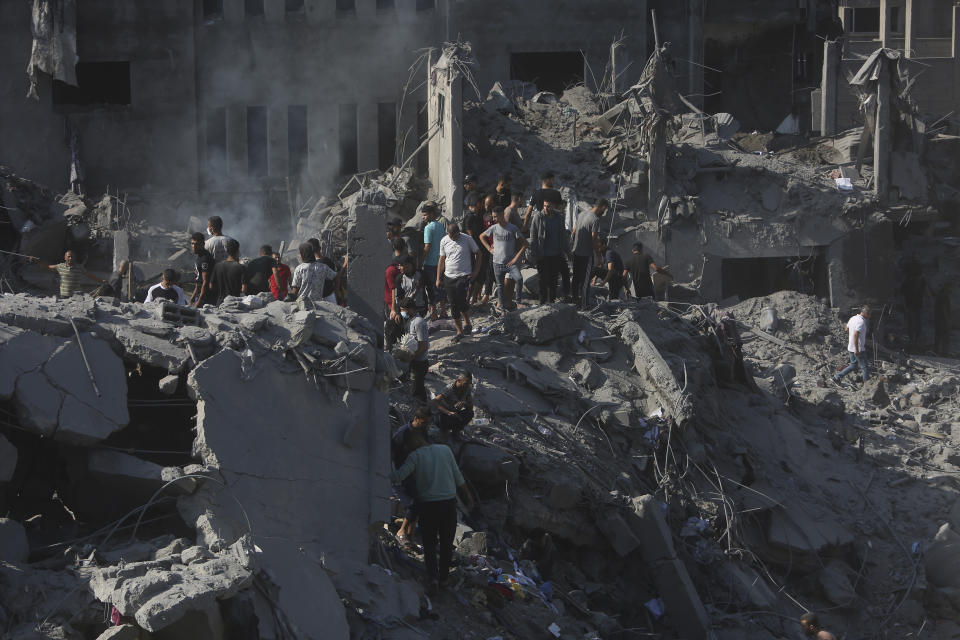 Palestinians look for survivors in the rubble of a destroyed building following an Israeli airstrike in Bureij refugee camp, Gaza Strip, Thursday, Nov. 2, 2023. (AP Photo/Mohammed Dahman)