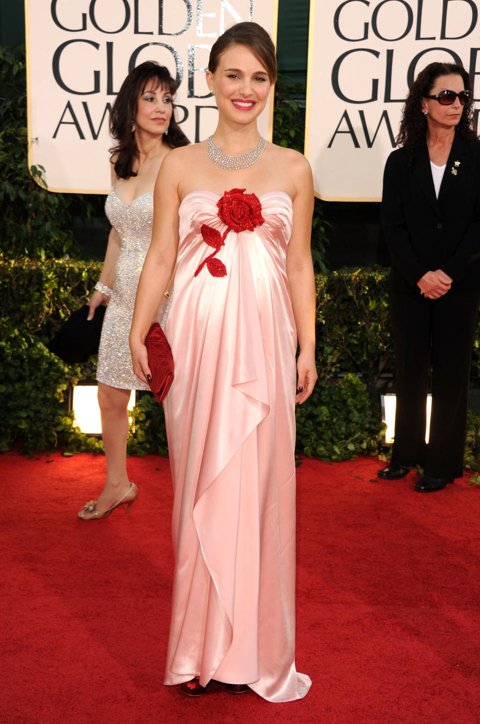 Natalie Portman wore a pink silk Viktor & Rolf gown with red floral detail the 2011 Golden Globe Awards. (Image via Getty Images)