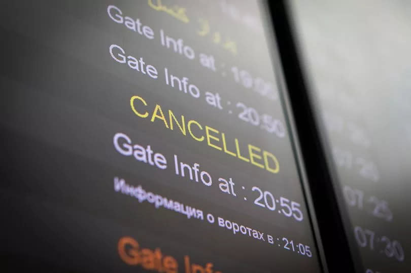 Flight cancelled illuminated on airport arrivals board