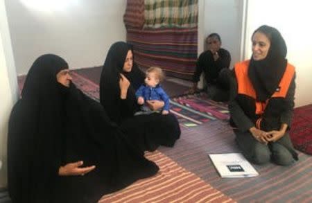 An Afghan refugee family talks to a Norwegian Refugee Council aid worker in their house in the Bardsir settlement for Afghan refugees in Kerman province, Iran October 22, 2016. REUTERS/Gabriela Baczynska