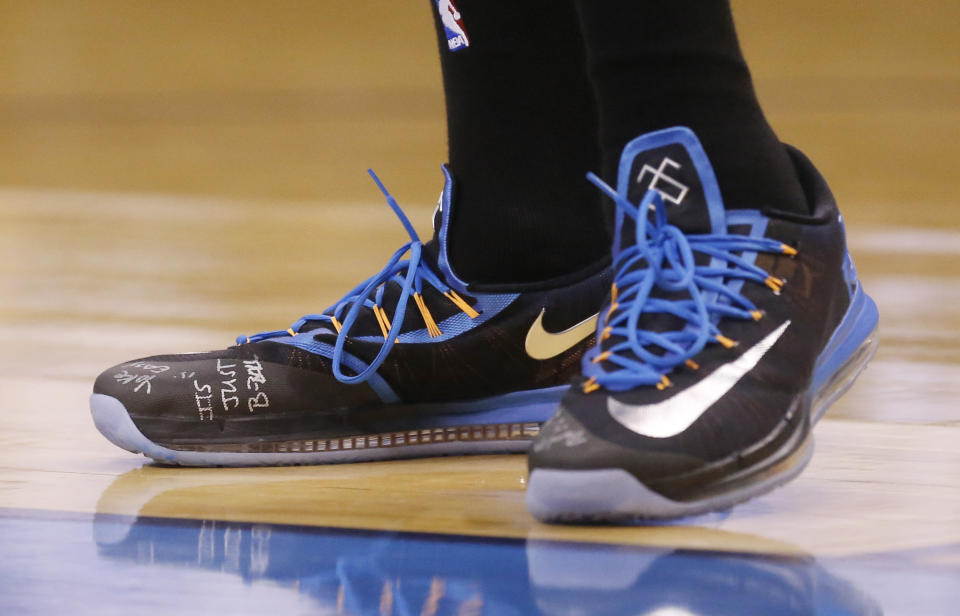 Oklahoma City Thunder forward Kevin Durant has the phrase "It's Just B-Ball" written on his shoes as the Thunder face the Memphis Grizzlies in Game 5 of an opening-round NBA basketball playoff series in Oklahoma City, Tuesday, April 29, 2014. (AP Photo)