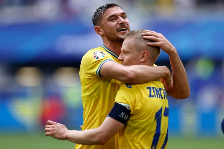 Ukraine match-winner <a class="link " href="https://sports.yahoo.com/soccer/players/814918/" data-i13n="sec:content-canvas;subsec:anchor_text;elm:context_link" data-ylk="slk:Roman Yaremchuk;sec:content-canvas;subsec:anchor_text;elm:context_link;itc:0">Roman Yaremchuk</a> embraces Oleksandr Zinchenko after the 2-1 victory over Slovakia at Euro 2024 (KENZO TRIBOUILLARD)