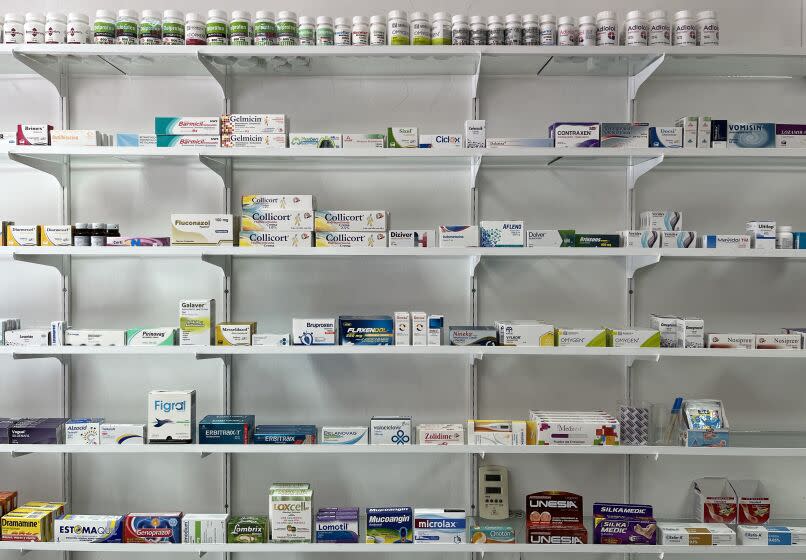 PUERTO VALLARTA, MEXICO MAY 5, 2023 - Medications are lined up on wide shelves in a pharmacy in Puerto Vallarta. Counterfeit pills, Times reporters found, are often kept in containers under the counter or in a back room. (Connor Sheets / Los Angeles Times)