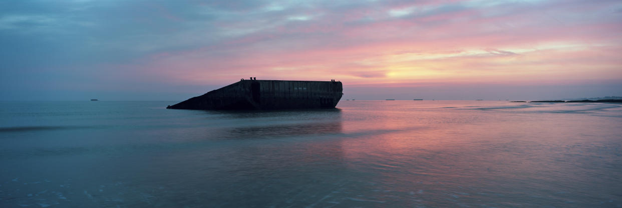 Sun rises over the remains of a section of the World War II Allied temporary Mulberry harbor built for the D-Day invasion, on what was known as Gold Beach, on May 01, 2019 in Arromanches, on the Normandy coast, France. (Photo: Dan Kitwood/Getty Images)