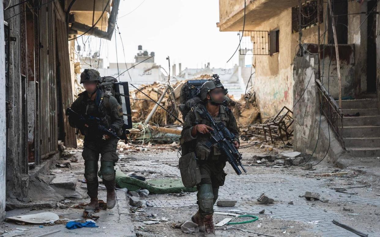 IDF soldiers patrol the streets in Gaza