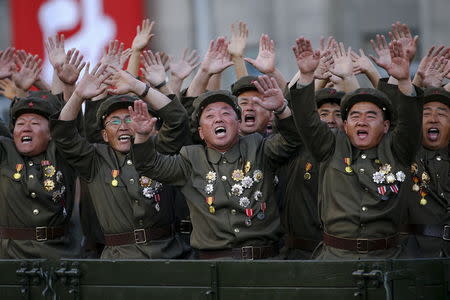 Veteran soldiers react as their truck drives past a stand with North Korean leader Kim Jong Un during the parade celebrating the 70th anniversary of the founding of the ruling Workers' Party of Korea, in Pyongyang October 10, 2015. REUTERS/Damir Sagolj