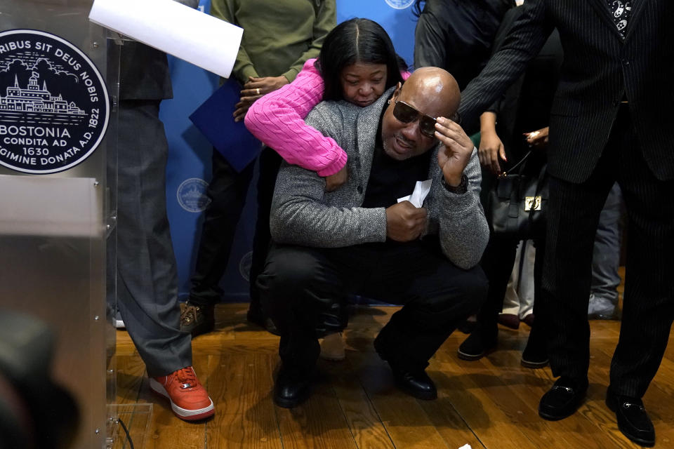 Joseph Bennett, below, nephew of Willie Bennett, who was wrongly accused in the 1989 death of Carol Stuart, is comforted by a family member as he becomes emotional during a news conference, Wednesday, Dec. 20, 2023, in Boston. Boston Mayor Michelle Wu issues a formal apology to Alan Swanson and Willie Bennett during the news conference for their wrongful arrests following the 1989 death of Carol Stuart, whose husband, Charles Stuart, had orchestrated her murder. (AP Photo/Steven Senne)