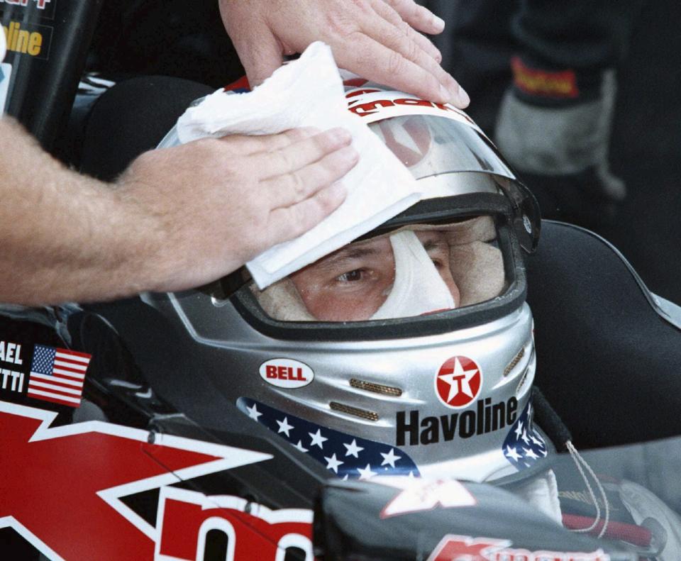 FILE - Michael Andretti of Nazareth, Pa. gets his helmet cleaned Saturday morning Aug. 16, 1997, at Road America in Elk Hart Lake, Wis., during a morning practice session for Sunday's Texaco-Havoline 200. Andretti won the race last year. The FIA on Monday, Oct. 2, 2023, said Michael Andretti meets all required criteria to field a future Formula One team. (AP Photo/Mike Roemer, File)