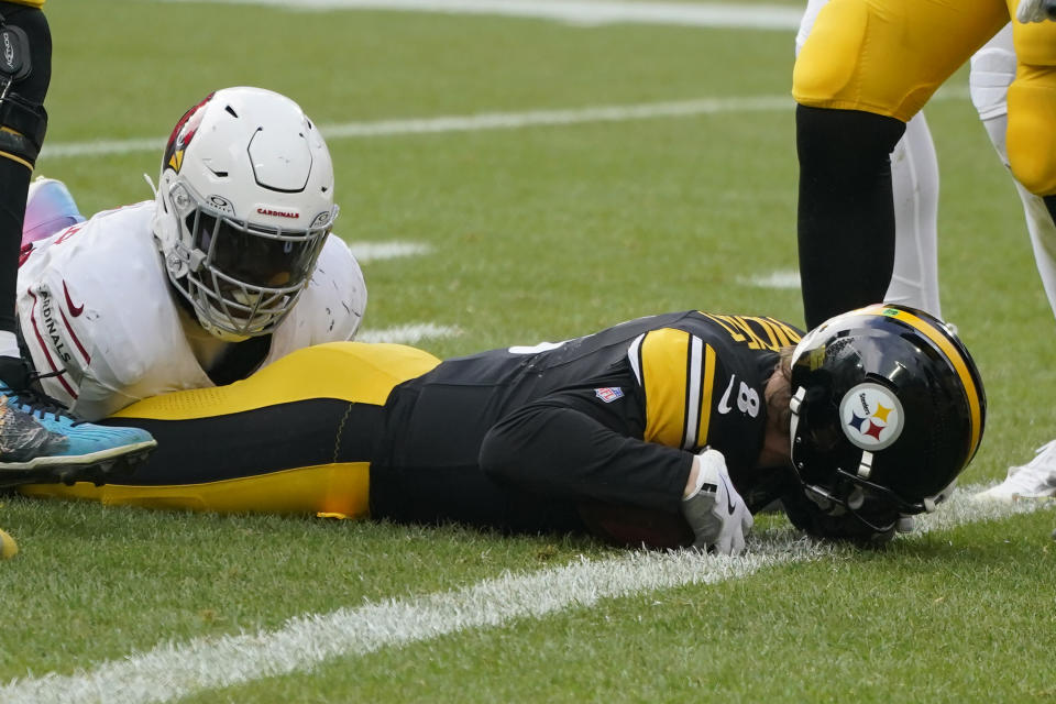 Pittsburgh Steelers quarterback Kenny Pickett, right, is stopped just short of the endzone by Arizona Cardinals defensive end Jonathan Ledbetter, left, during the first half of an NFL football game, ,Sunday, Dec. 3, 2023, in Pittsburgh. (AP Photo/Gene J. Puskar)