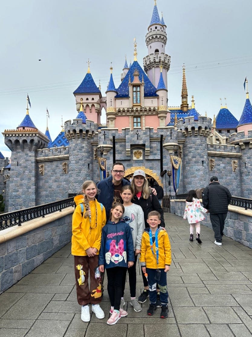 Author Daryl Austin and his family at Disneyland at a castle 