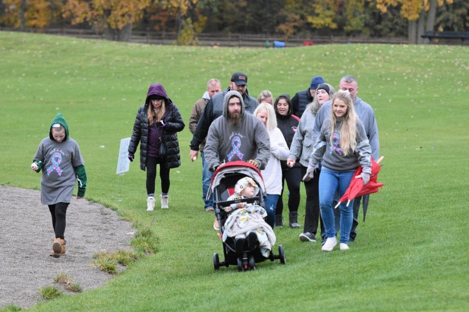 Families walk at a candlelight vigil during the 5th Annual Jacob’s Joy Remembrance Walk at Hopfinger Zimmerman Memorial Park on Oct. 21.