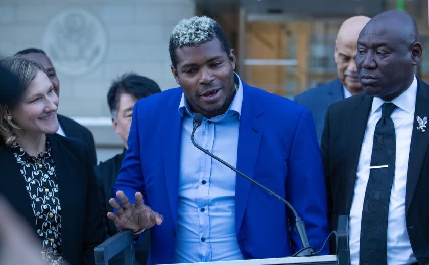 LOS ANGELES, CA - February 11, 2023: Former Dodgers outfielder Yasiel Puig, center, speaks at a news conference outside the federal courthouse in downtown Los Angeles on Saturday February 11, 2023 in Los Angeles, CA. (Brian van der Brug / Los Angeles Times)