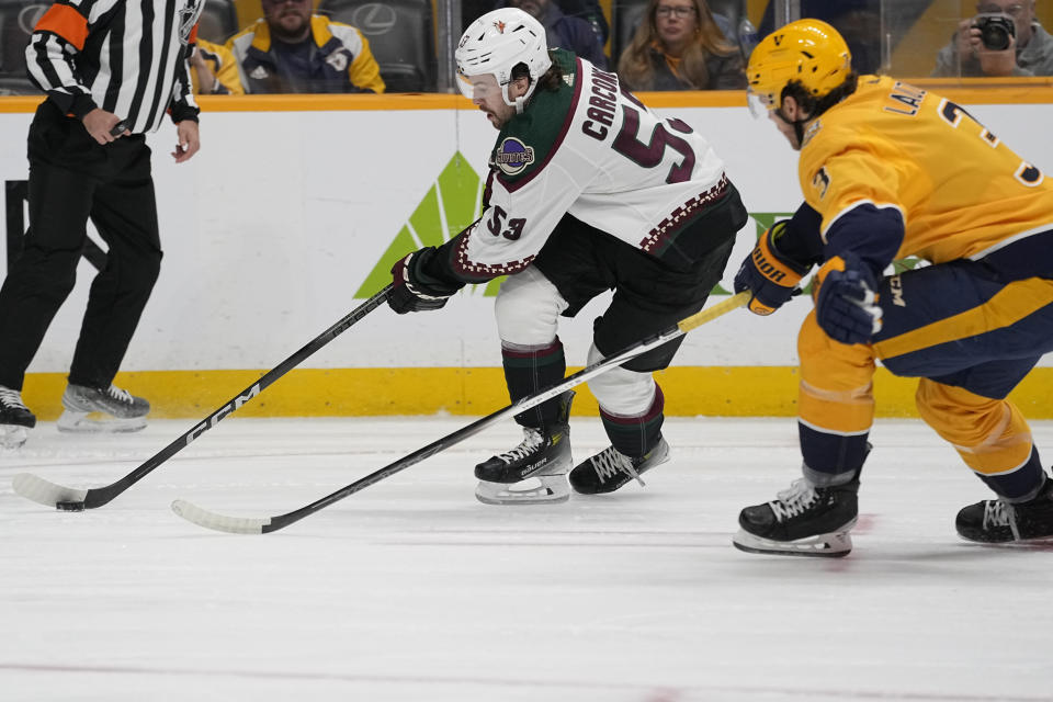 Arizona Coyotes left wing Michael Carcone (53) skates the puck past Nashville Predators defenseman Jeremy Lauzon (3) during the first period of an NHL hockey game Saturday, Nov. 11, 2023, in Nashville, Tenn. (AP Photo/George Walker IV)