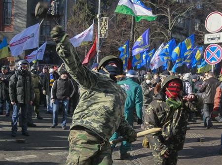 Anti-government protesters throw stones towards Interior Ministry officers during a rally near the building of Vekhovnaya Rada, Ukraine's house of parliament, in Kiev, February 18, 2014. REUTERS/Gleb Garanich