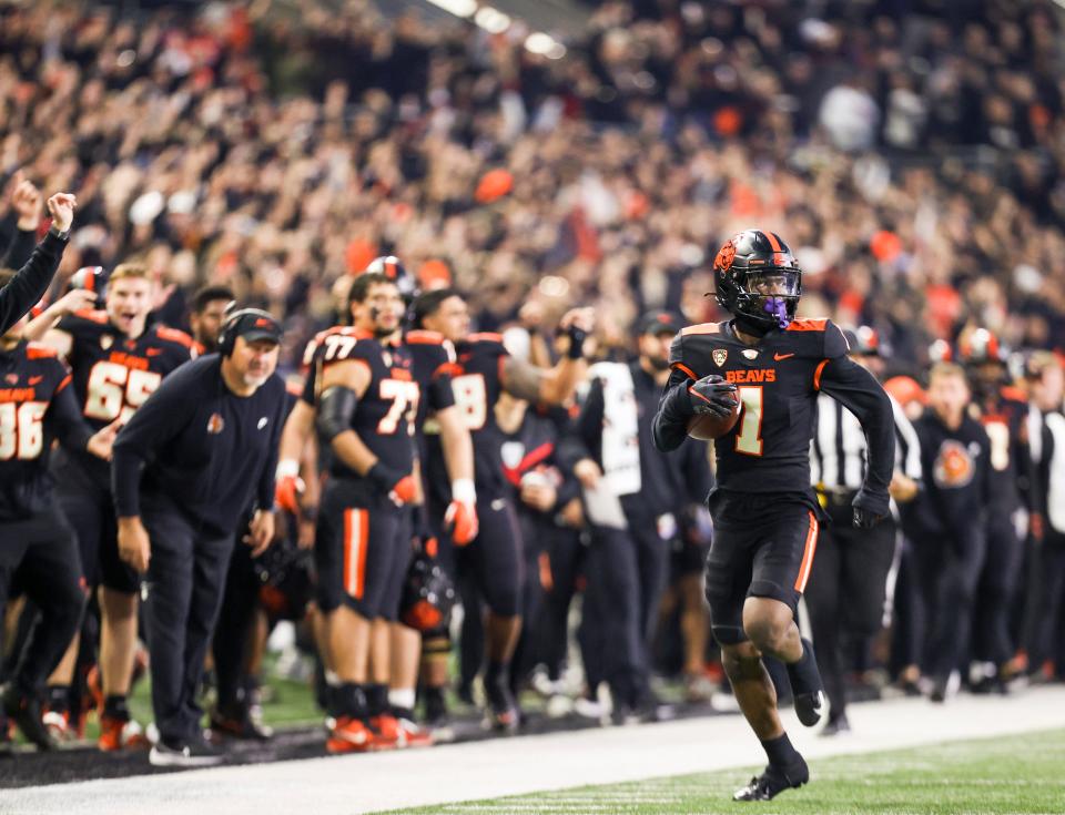Oregon State Beavers defensive back Ryan Cooper Jr. (1) intercepts the ball to score a touchdown during the first half of the game against the UCLA Bruins on Saturday, Oct. 14, 2023 at Reser Stadium in Corvallis, Ore.