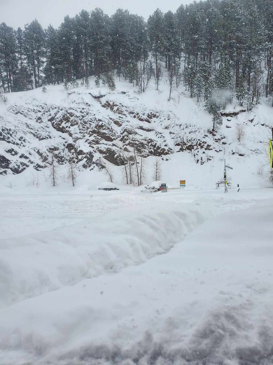 This image provided by Historic Bullock Hotel Manager Vicki Weekly shows snow piled in front of the Historic Bullock Hotel in Deadwood, S.D., on Tuesday, Dec. 13, 2022. (Vicki Weekly via AP)