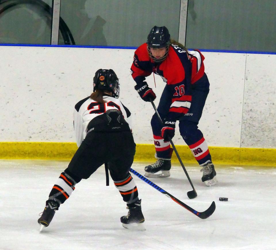 Ciara Folan #10 of Quincy/North Quincy looks to get the puck past Megan McGowan of Stoughton in their game on Monday, Jan. 23, 2023.