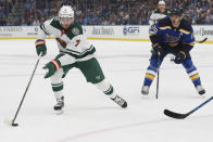 Minnesota Wild's Dmitry Kulikov (7) works the puck as St. Louis Blues' Brayden Schenn (10) defends during the first period in Game 6 of an NHL hockey Stanley Cup first-round playoff series on Thursday, May 12, 2022, in St. Louis. (AP Photo/Michael Thomas)