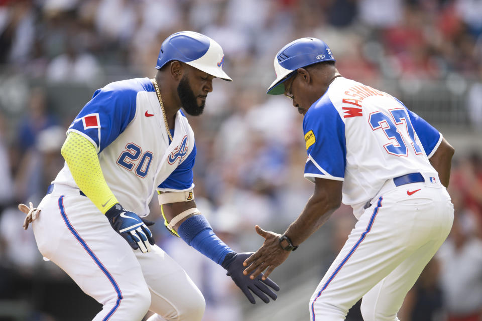 Atlanta Braves designated hitter Marcell Ozuna and third base coach Ron Washington celebrates Ozuna's home run in the second inning of a baseball game against the Washington Nationals, Saturday, June 10, 2023, in Atlanta. (AP Photo/Hakim Wright Sr.)