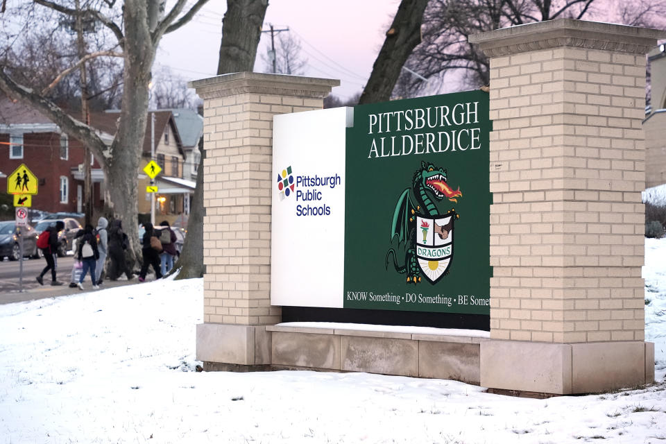 Students arrive for classes at Taylor Allderdice High School in the Squirrel Hill neighborhood of Pittsburgh, Tuesday, Jan. 23, 2024. The mother of an intellectually disabled girl who allegedly was led from school grounds by three male students and sexually assaulted in a Starbucks bathroom and a nearby empty building has filed a lawsuit Wednesday, Jan 24, 2024, accusing Starbucks, Pittsburgh Public Schools and a property management company of negligence. (AP Photo/Gene J. Puskar)