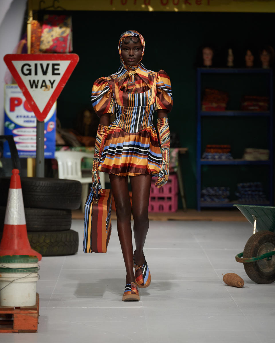 a Tolu Coker model wears Ugg clogs while walking the runway