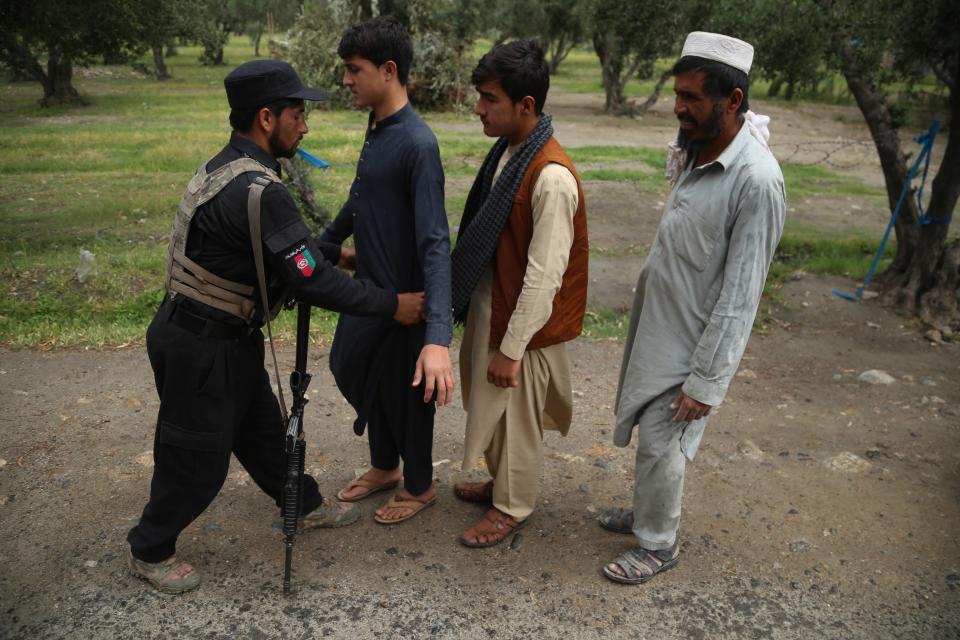 Afghan security official check people at a checkpoint in Jalalabad, 15 April 2021EPA