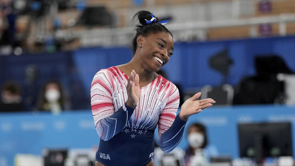 Simone Biles, of the United States, finishes on the balance beam during the artistic gymnastics women's apparatus final at the 2020 Summer Olympics, Tuesday, Aug. 3, 2021, in Tokyo, Japan. (AP Photo/Ashley Landis)