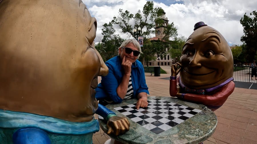 Kimber Fiebiger smiled with the newly installed Humpty Dumpty duo, where one can stop downtown to play chess or checkers with them.