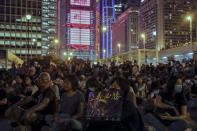 A woman holds a placard which reads "Justice will win" as protesters attend a prayer rally at Edinburgh Place in Hong Kong, Saturday, Oct. 19, 2019. Hong Kong pro-democracy protesters are set for another weekend of civil disobedience as they prepare to hold an unauthorized protest march to press their demands. (AP Photo/Mark Schiefelbein)