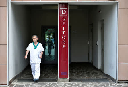 A nurse walks through the entrance of the San Raffaele hospital, where former Italian prime minister Silvio Berlusconi was hospitalized for a heart problem, in Milan, Italy June 10, 2016. REUTERS/Flavio Lo Scalzo