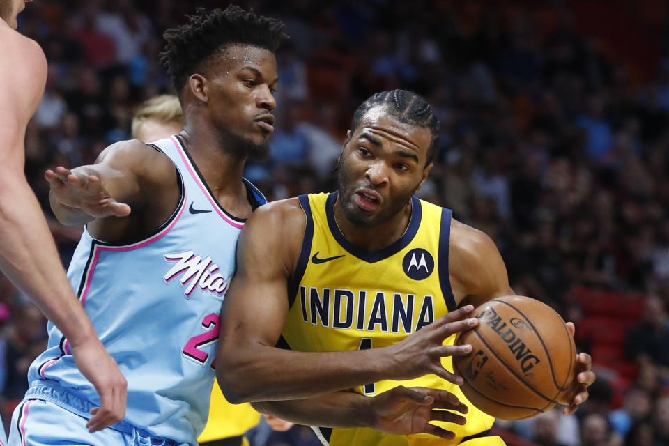 Indiana Pacers forward T.J. Warren (1) drives against Miami Heat forward Jimmy Butler (22) during the first half of an NBA basketball game Friday, Dec. 27, 2019, in Miami. (AP Photo/Wilfredo Lee)