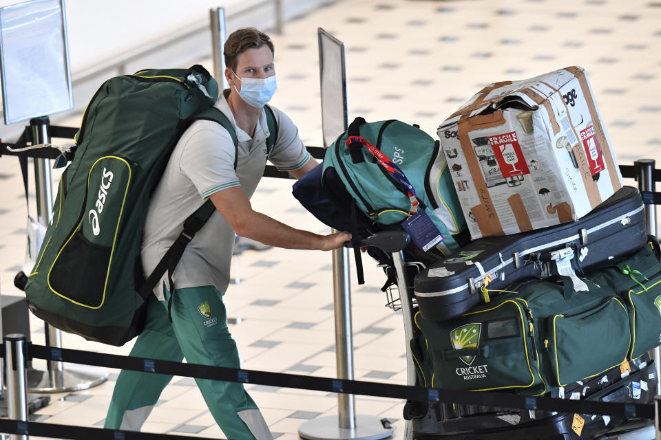 Australian cricket player Steve Smith arrives at the Brisbane International Airport, Tuesday, Nov. 16, 2021, following Australia's victory in the ICC Men's T20 World Cup final. Members of the Australian and England cricket teams flew into Brisbane, where they will quarantine for 14 days ahead of the Ashes series. (Darren England/AAP Image via AP)