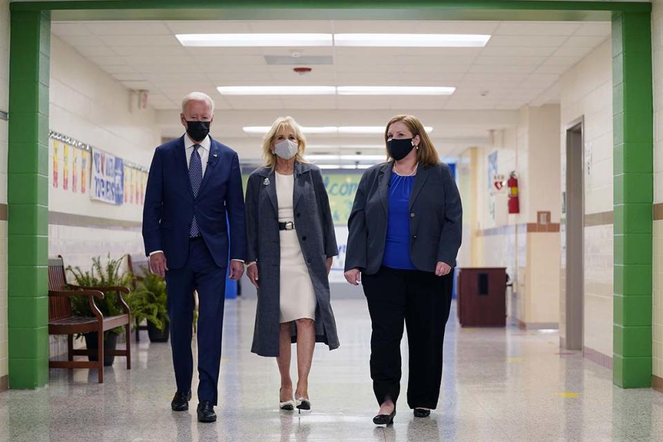 President Joe Biden and first lady Jill Biden, walk with Principal Kelly Denny, during a visit to Yorktown Elementary School, Monday, May 3, 2021, in Yorktown, Va. (AP Photo/Evan Vucci)