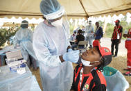 A woman takes a rapid COVID-19 test prior to the African Cup of Nations 2022 group B soccer match between Senegal and Guinea at the Omnisport Stadium in Bafoussam, Cameroon, Friday, Jan. 14, 2022. (AP Photo/Sunday Alamba)