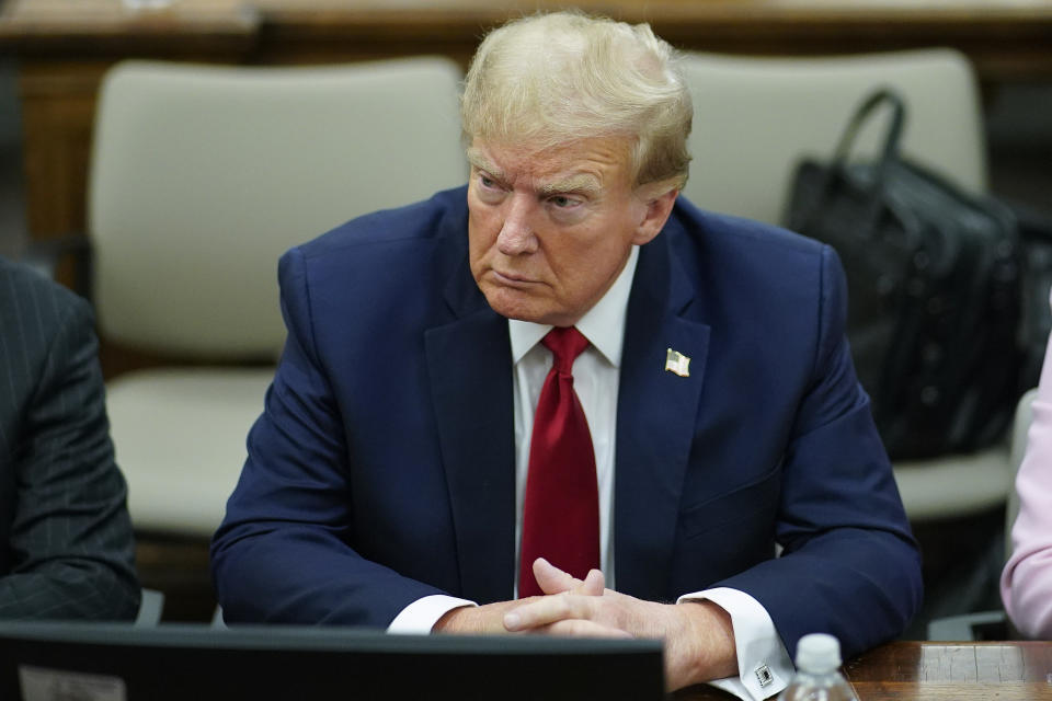 FILE - Former President Donald Trump, center, sits at the defense table with his attorney's Christopher Kise, left, and Alina Habba, at New York Supreme Court, Thursday, Dec. 7, 2023, in New York. (AP Photo/Eduardo Munoz Alvarez, Pool, File)