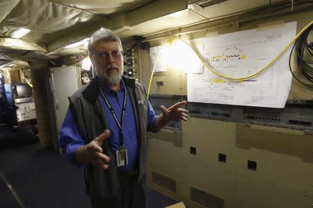 NASA scientist William Krabill talks while on board a NASA P-3 plane at the NASA Wallops flight facility on Wallops Island, Virginia October 24, 2013. REUTERS/Kevin Lamarque