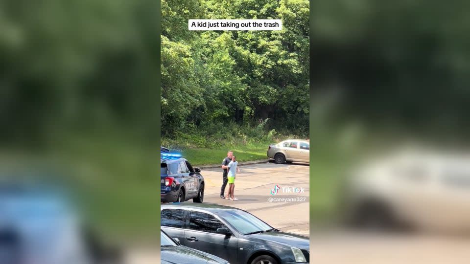 Tashawn Bernard is handcuffed by police while taking out the trash. - @careyann327/TikTok