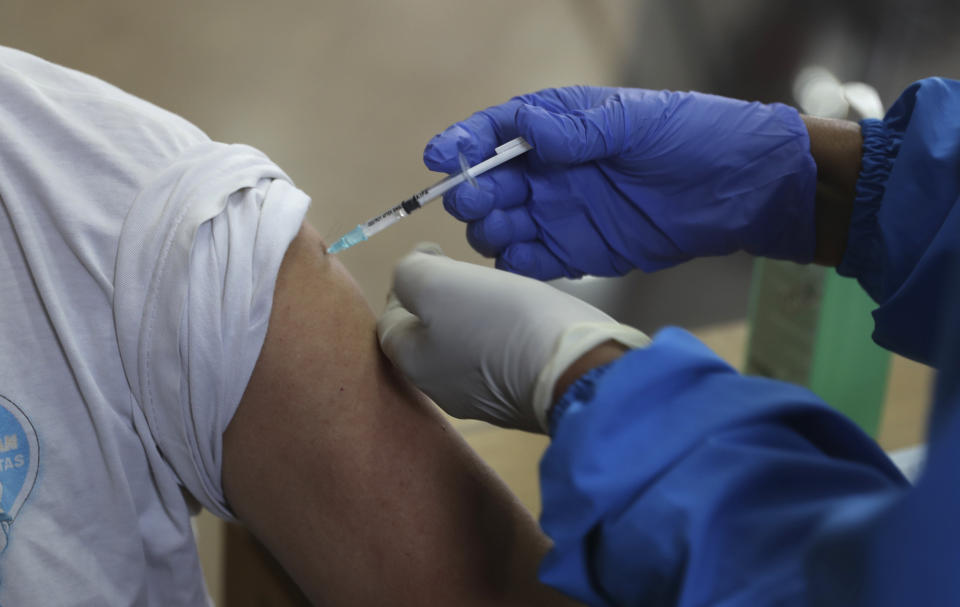 A man receives shot of Sinovac COVID-19 vaccine during mass vaccination in Jakarta, Indonesia. Thursday, April 15, 2021. (AP Photo/ Achmad Ibrahim)