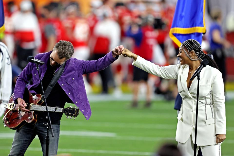 Jazmine Sullivan and Eric Church perform the national anthem before Super Bowl 55 between the Kansas City Chiefs and the Tampa Bay Buccaneers at Raymond James Stadium.  