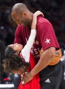 In this Feb. 14, 2016, file photo, Los Angeles Lakers Kobe Bryant (24) hugs his daughter Gianna on the court in warm-ups before first half NBA All-Star Game basketball action in Toronto. Bryant, his 13-year-old daughter, Gianna, and several others are dead after their helicopter went down in Southern California on Sunday, Jan. 26, 2020. (Mark Blinch/The Canadian Press via AP)