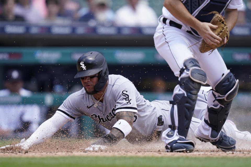 Chicago White Sox's Yoan Moncada scores ahead of the throw to Detroit Tigers catcher Jake Rogers during the fourth inning of a baseball game, Sunday, June 13, 2021, in Detroit. (AP Photo/Carlos Osorio)
