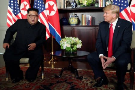 FILE PHOTO: U.S. President Donald Trump and North Korea's leader Kim Jong Un meet in a one-on-one bilateral session at the start of their summit at the Capella Hotel on the resort island of Sentosa, Singapore June 12, 2018. REUTERS/Jonathan Ernst